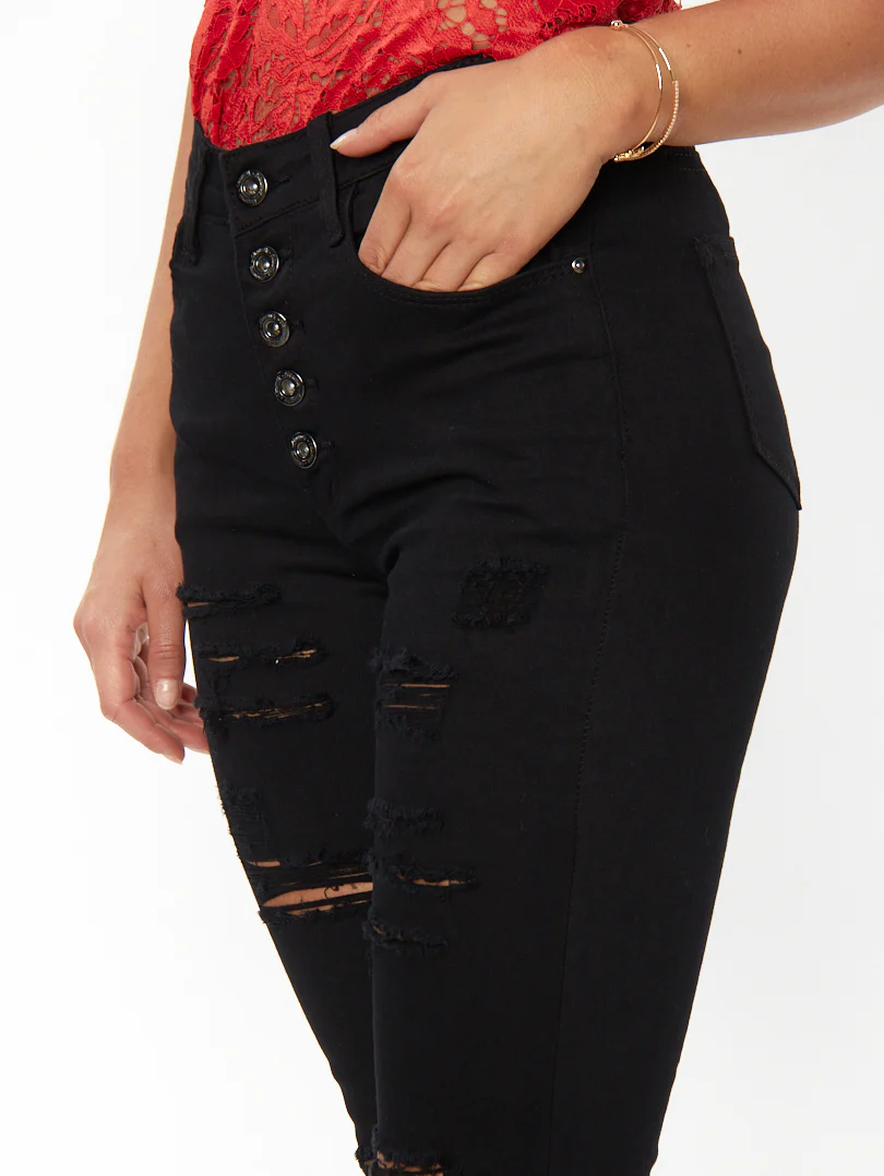 Jean skinny noir à boutons et déchirures légères