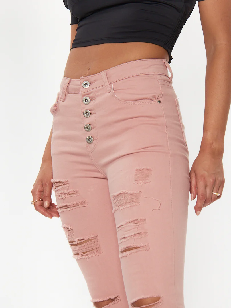 Jean skinny à boutons et déchirures légères