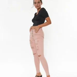 Jean skinny à boutons et déchirures légères